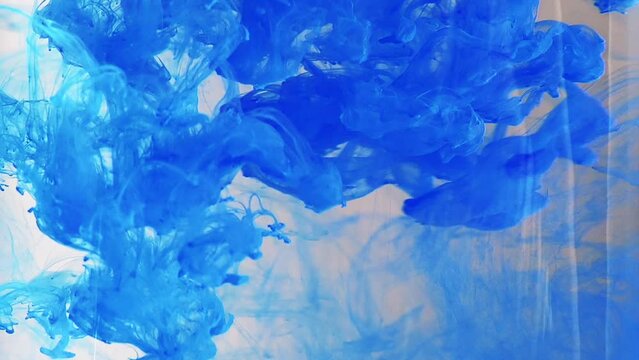 Blue color flowing in smoke forms, smooth abstract moving by acrylic paint
