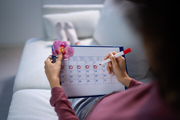 African Woman Using Menstrual Cycle