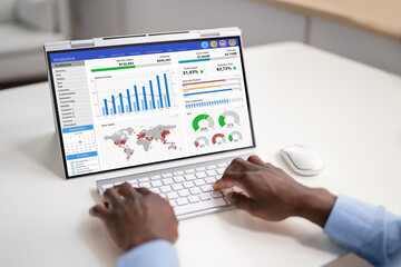 Obraz na płótnie Canvas African Businessman Using Analytics Data KPI Dashboard