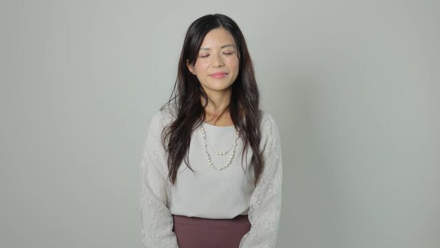 Asian beautiful woman smiles at the camera. Happy, Joy, Delighted. White background.