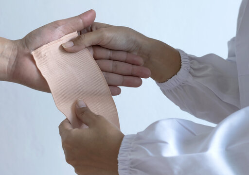 Close Up Nurse Hands Bandaging To Patient Hand On White Background ,  Hands Concept