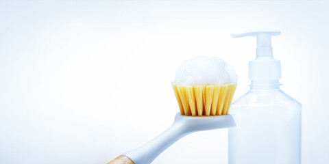 eco friendly brush with foam for washing dishes on white background with copy space.