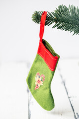 christmas stocking hanging in tree on white