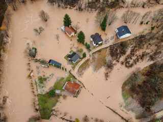 Flooded village, fields, farms and houses, aerial drone view. Aftermath of devastating river flood and landslide. Catastrophic floods. Overflowing river, view from above.	
