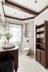 Modern bathroom interior with stylish mirror and vessel sink.