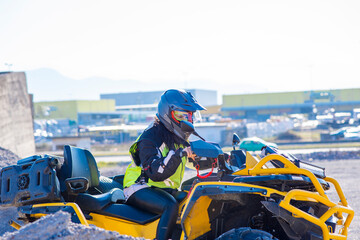 Girl driving ATV on dirt road