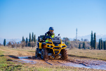 Obraz premium Girl driving ATV on dirt road