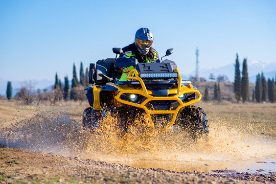 Girl driving ATV on dirt road