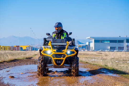 Girl driving ATV on dirt road