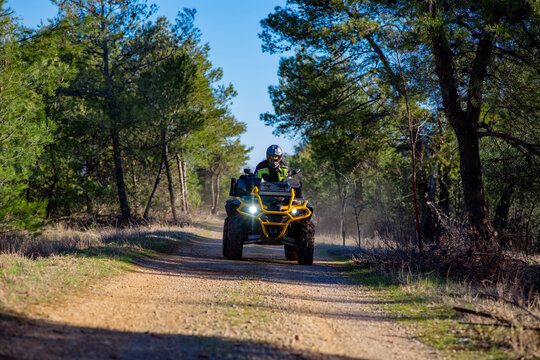 Girl driving ATV on dirt road