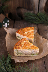 Quiche with chicken and broccoli on a wooden table