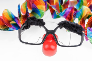 Black carnival glasses with a red nose. The clown's face. Isolated