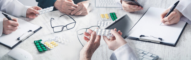 Doctor giving pills to elderly woman. Health, Medicine, Care