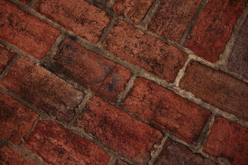 a dark red aged brick floor