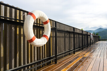 White-red lifebuoy hanging on the wall near pool in Chiang Mai, Thailand