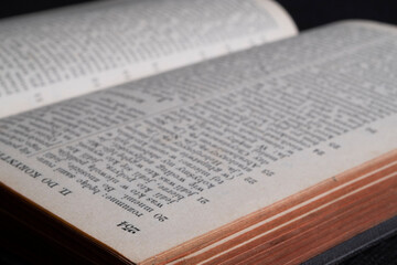 Old book on a black background, macro photo