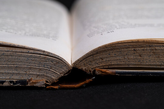 Old book on a black background, macro photo