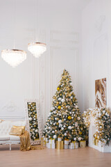 Interior of luxury interior with fireplace, comfortable sofa and chandelier decorated with Christmas tree and gifts
