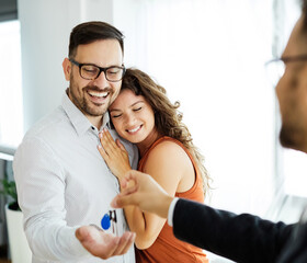 young couple new house keys buy real estate home agent agreement investment apartment owner property