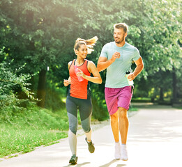 Fototapeta premium fitness woman park exercise lifestyle outdoor sport healthy couple nature active young fit training athlete