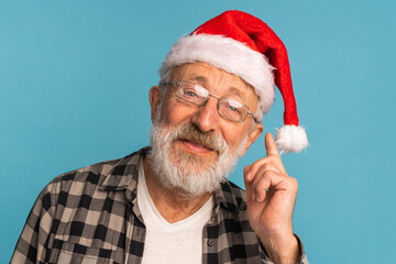 Portrait of happy emotions Santa Claus excited looking at camera on blue background