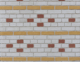 Colored brickwork, white bricks with yellow rows and red brick patterns
