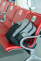 A lonely backpack at the airport in the waiting room. Forgotten luggage. Lost hand luggage.