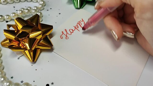 Video with the inscription in red marker "Happy New Year"
Postcard with an inscription on the background of a garland and Christmas decorations