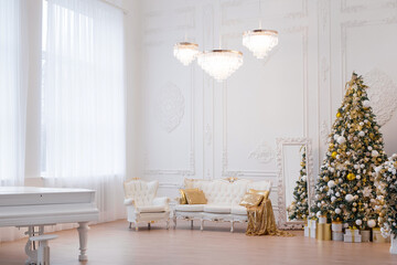 Interior of luxury interior with fireplace, comfortable sofa and chandelier decorated with Christmas tree and gifts