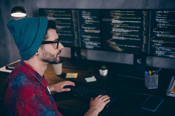 Photo of smart serious programmer wear spectacles creating start up software indoors workplace...