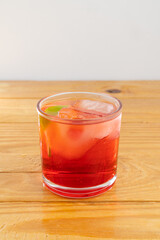 cocktail glass, on wood table