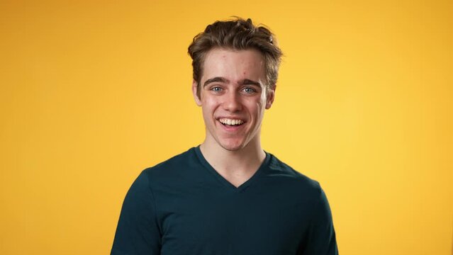 Portrait of smiling happy young hipster man 20s isolated on solid yellow background with copy space in studio