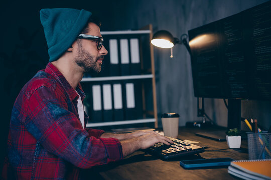 Photo of serious confident programmer wear spectacles playing game modern device indoors workplace workshop home