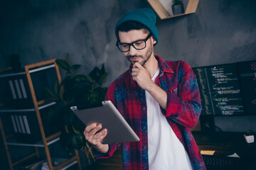 Photo of ponder pensive programmer wear spectacles arm chin reading instagram twitter ebook device...
