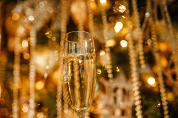 Champagne glasses against luxury glow golden rain decoration expensive holidays party