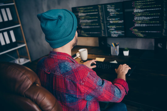 Photo of cool smart guy dressed eyewear watching making system administration modern device indoors workstation workshop home