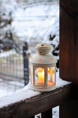 A beautiful lantern on a wooden porch.