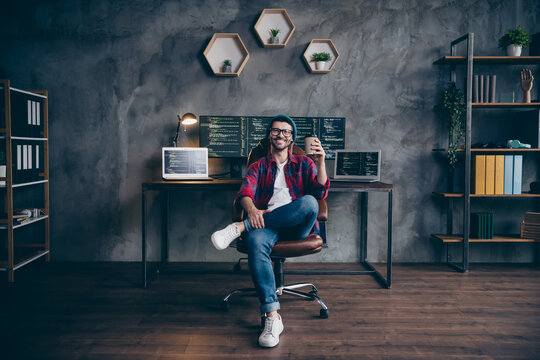 Photo of cheerful positive programmer wear spectacles enjoying tasty beverage indoors workplace workshop home