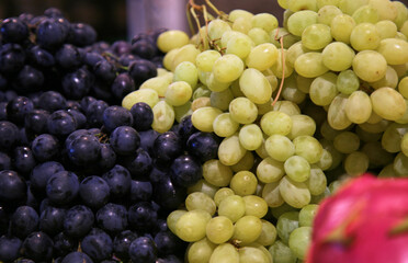 Healthy berries oh black and white grape on the market, selective focus