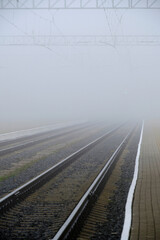 Railway track disappearing into fog.Rails going into fog, atmospheric weather.