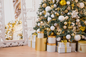 Beautiful New Year gift boxes with satin ribbon bow under Christmas tree.