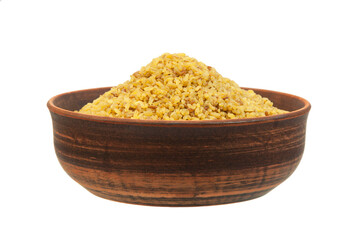 bulgur in a clay bowl on a white background. the concept of a good harvest of bulgur