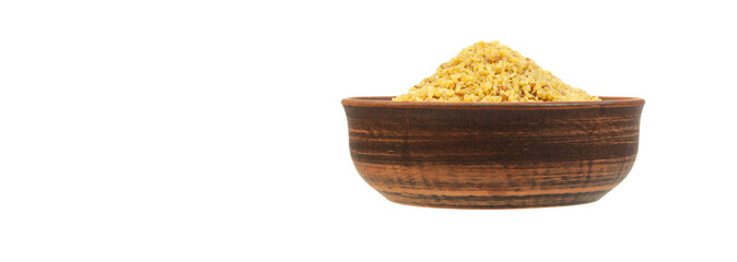 bulgur in a clay bowl on a white background. the concept of a good harvest of bulgur
