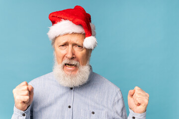 Happy confident cool old bearded Santa Claus winner raising fists celebrating triumph and success...