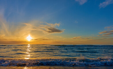 Fototapeta na wymiar sunset over ocean with a small ship silhouette on horizon line