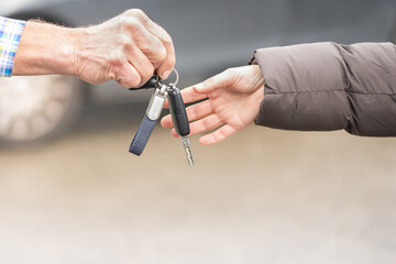 car key hands over Businessman  a woman in front of blurred car