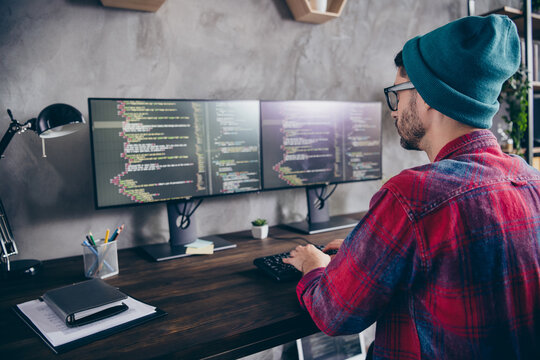 Photo of busy confident guy dressed eyewear hat writing code modern device indoors workstation workshop home