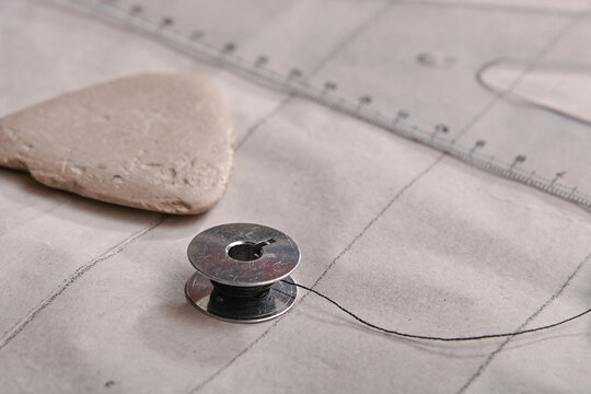 heated thread into the sewing machine needle
