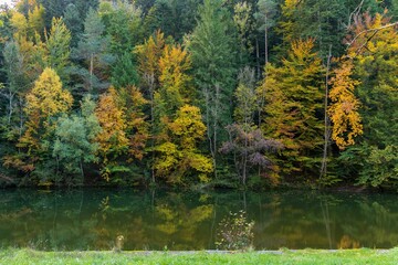 Beautiful landscape of the Areuse river on a colorful autumnal trees background