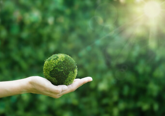 Green earth planet in hands with shining light. Save and protection Earth. Concept of the...